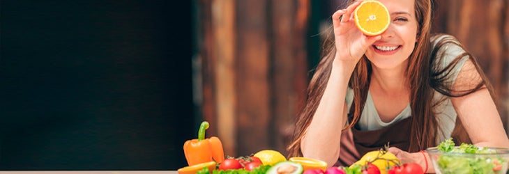 Contigo_1_joven-feliz-con-una-naranja-y-frutas-sobre-mesa-de-madera-en-mercado-saludable_730x250.jpg