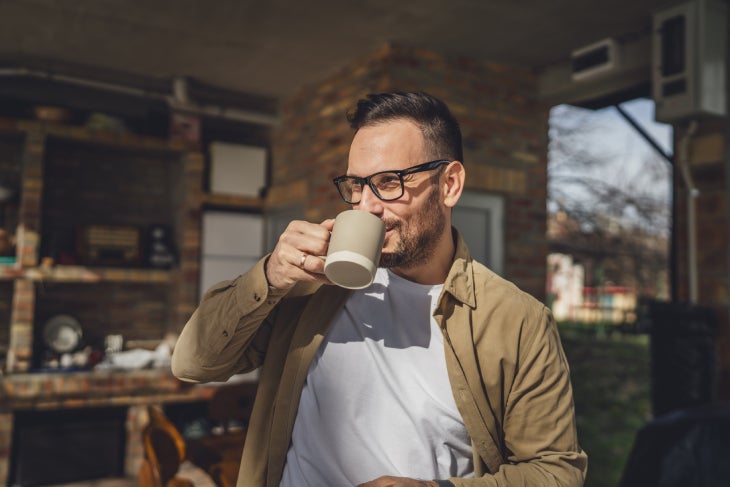 Hombre tomando una taza de NESCAFÉ® al inicio del día